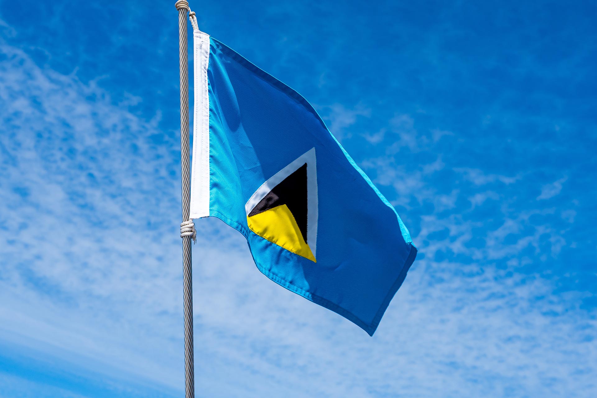 St. Lucia flag on a flagpole